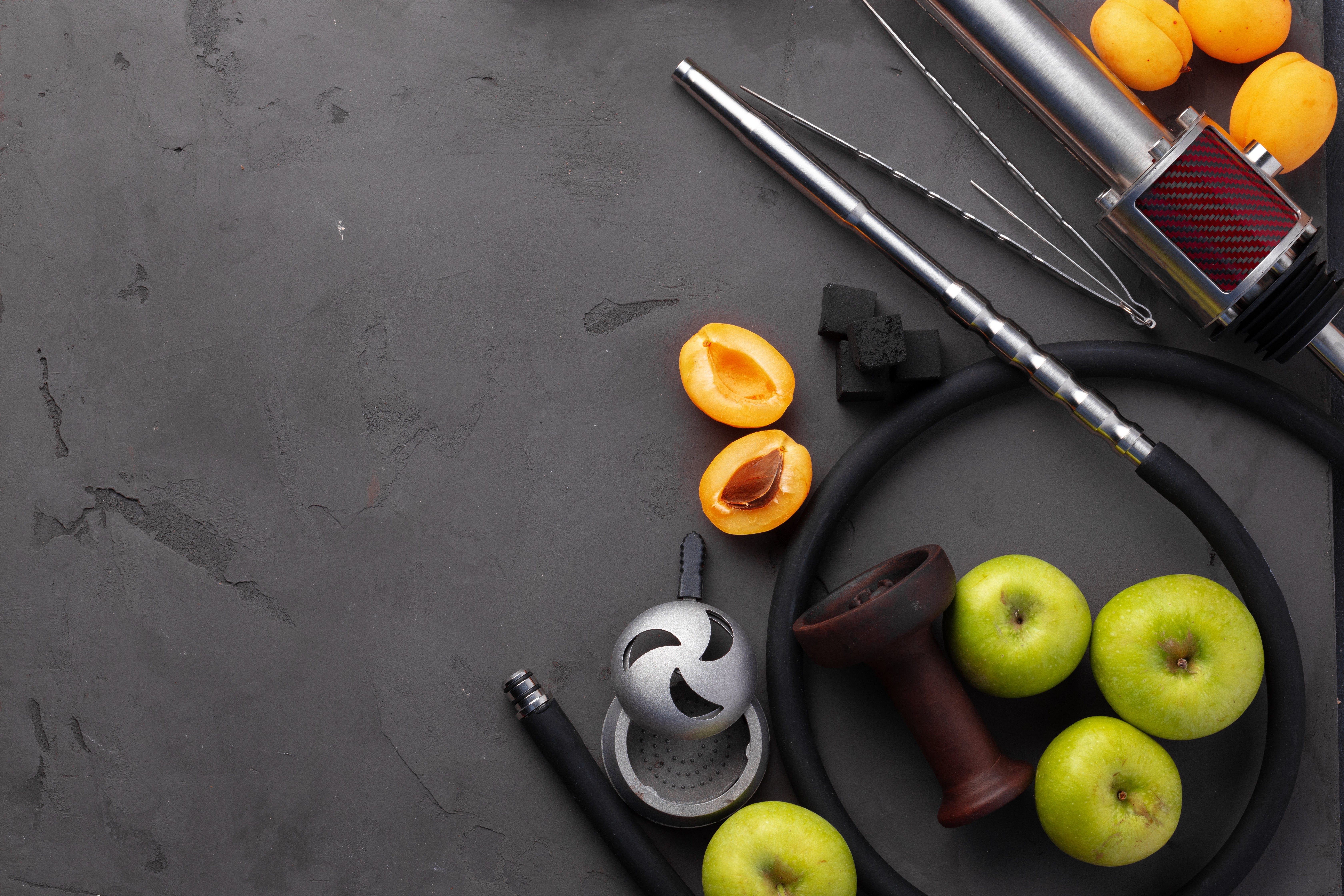 Hookah pipe and shaft with fruits on gray background