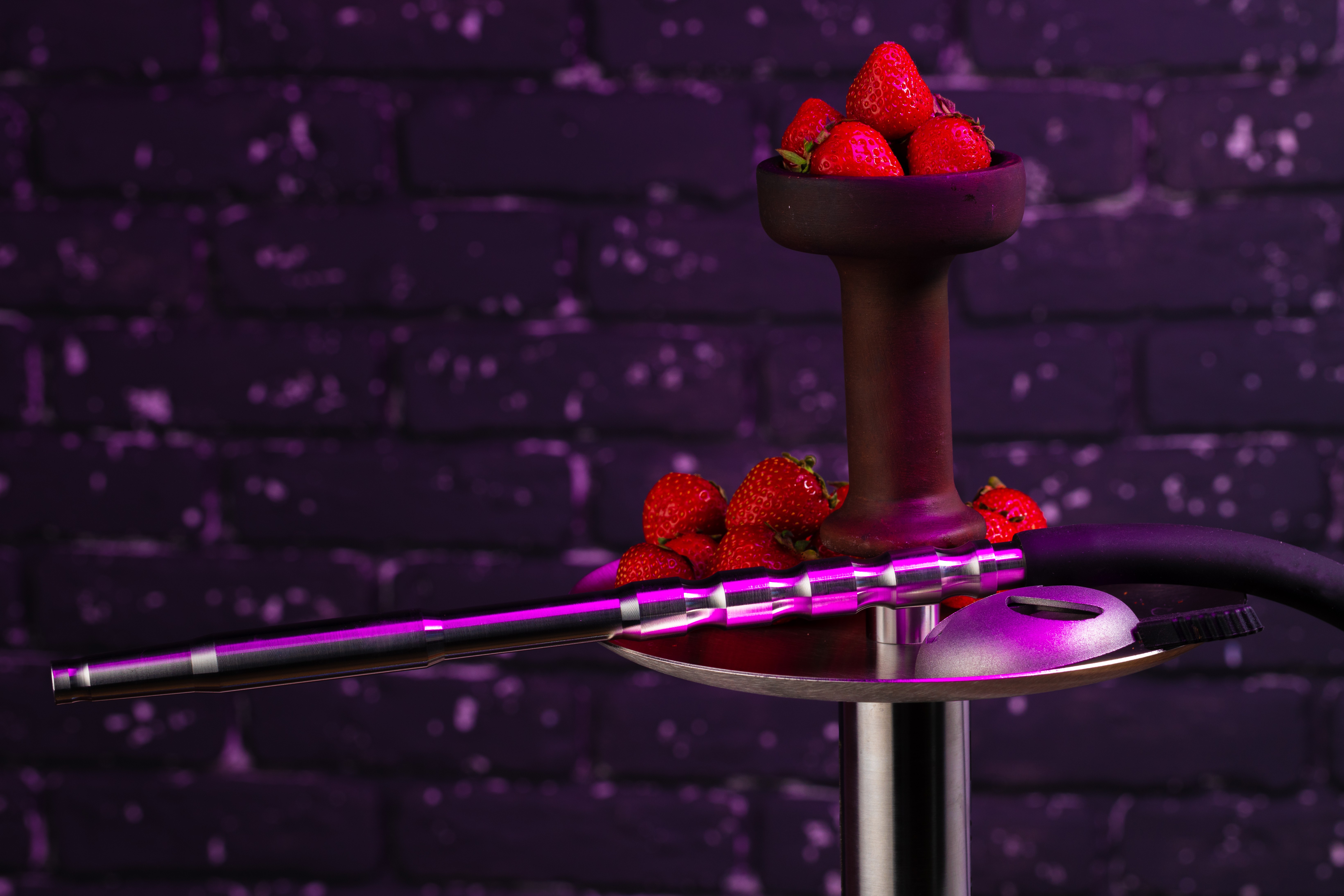Hookah with strawberry flavour close up on dark background